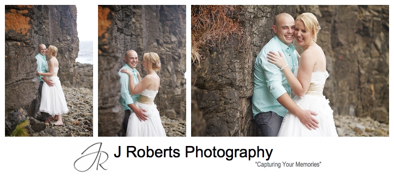 Laughing couple on the coastal cliff at Kiama - sydney wedding photographer 